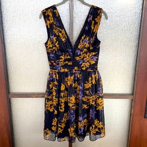 Dress the Population minidress in black with a pretty gold/periwinkle print. XS